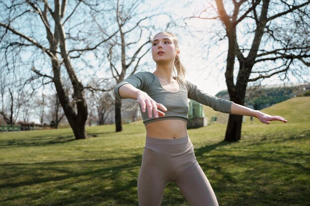 Medium shot woman exercising outdoors