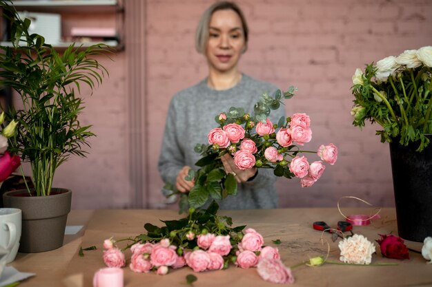 Medium shot woman at flower shop