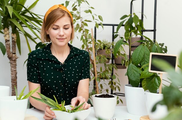 Medium shot woman gardening indoors