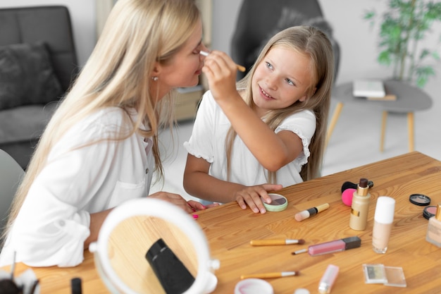 Medium shot woman getting make up on