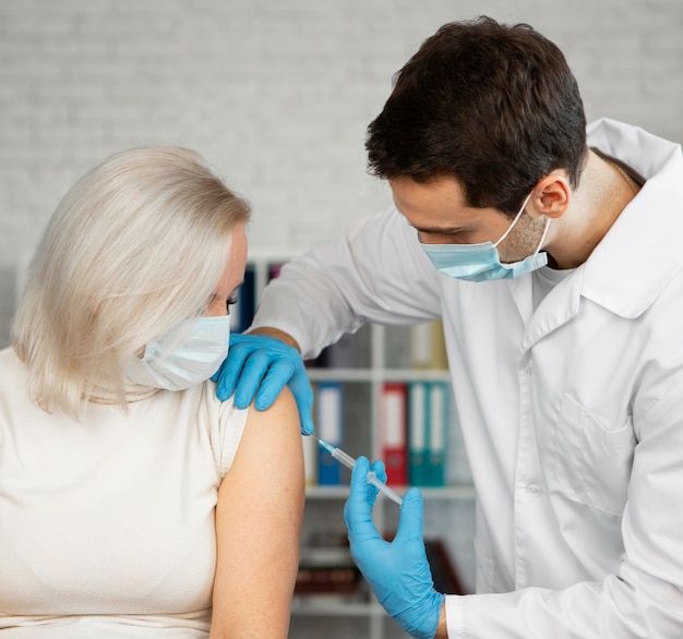 Medium shot woman getting a vaccine