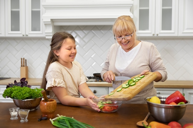 Medium shot woman and girl cooking together