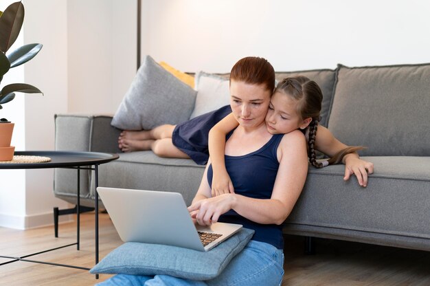 Medium shot woman and girl at home