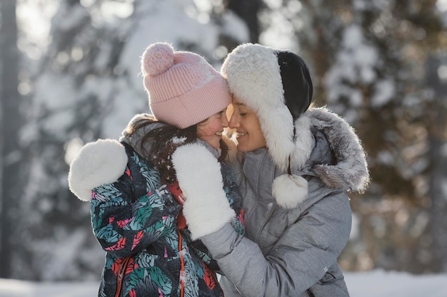 Medium shot woman and girl outdoors