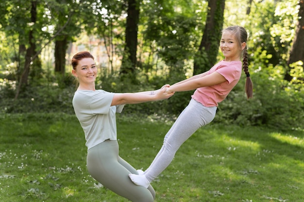 Medium shot woman and girl practicing together