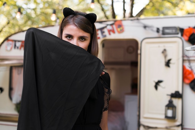 Free photo medium shot woman hiding behind scarf