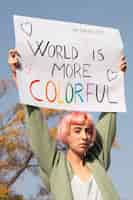 Free photo medium shot woman holding banner