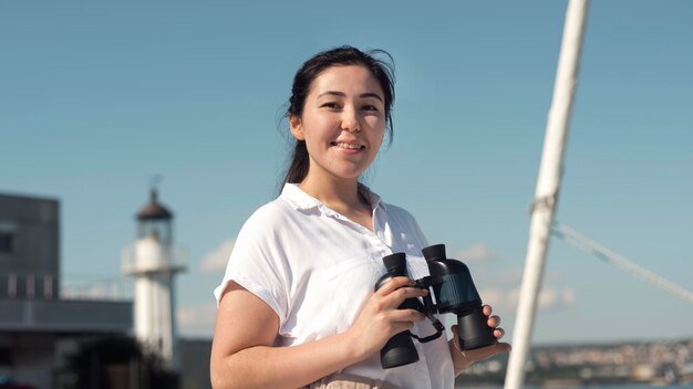 Medium shot woman holding binoculars