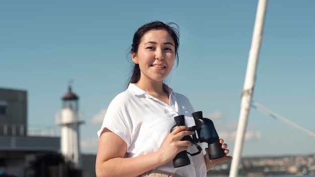 Medium shot woman holding binoculars