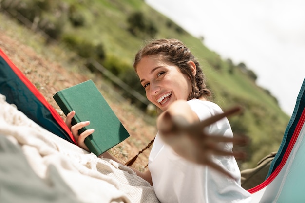 Medium shot woman holding book