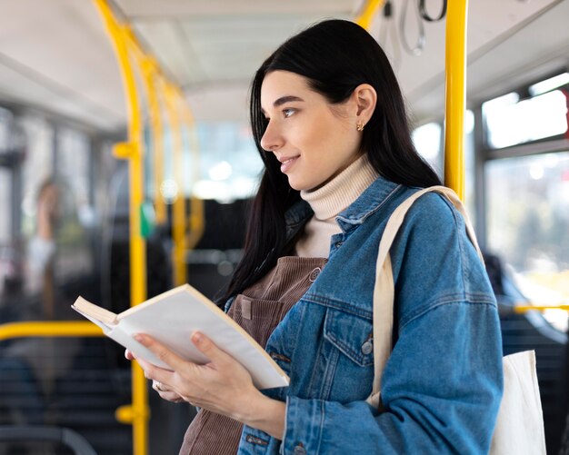 medium shot woman holding book