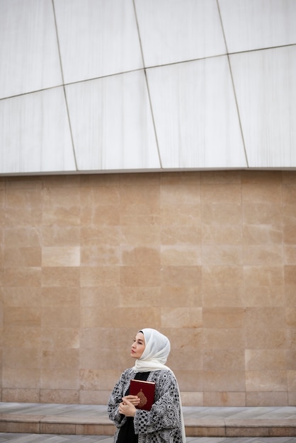 Medium shot woman holding book