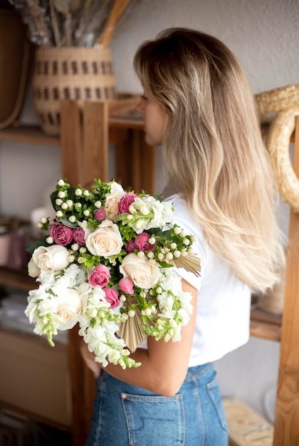 Medium shot woman holding bouquet