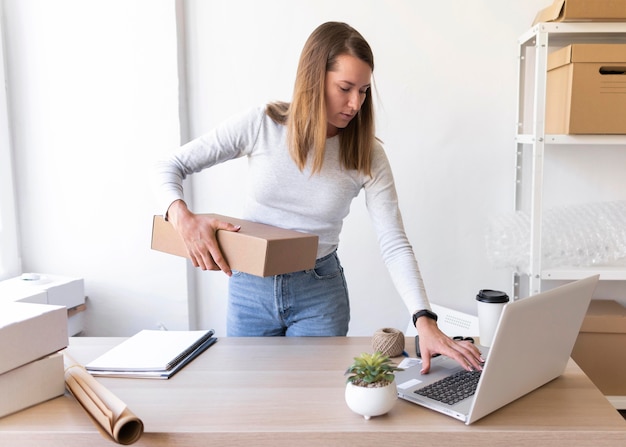 Medium shot woman holding box