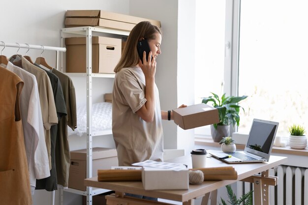 Medium shot woman holding box