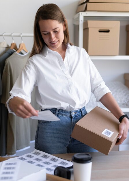 Medium shot woman holding box