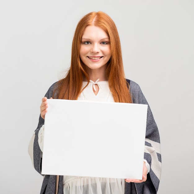 Medium shot woman holding canvas