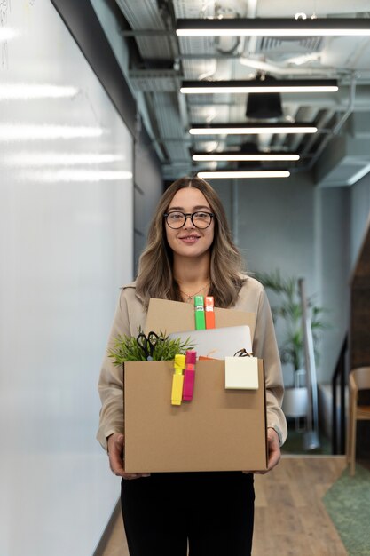 Medium shot woman holding cardboard box