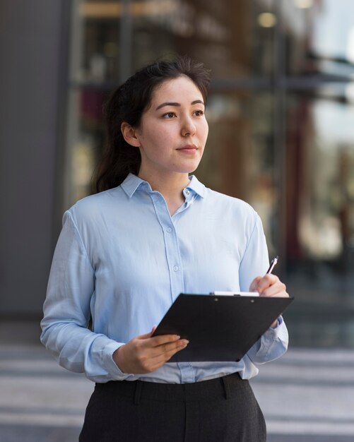 Medium shot woman holding clipboard