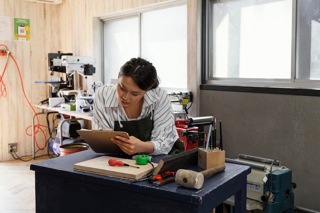 Medium shot woman holding clipboard