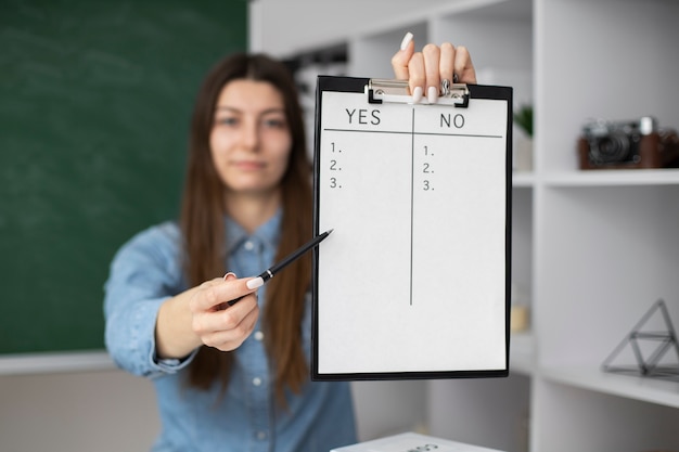 Medium shot woman holding clipboard