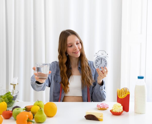 Medium shot woman holding clock