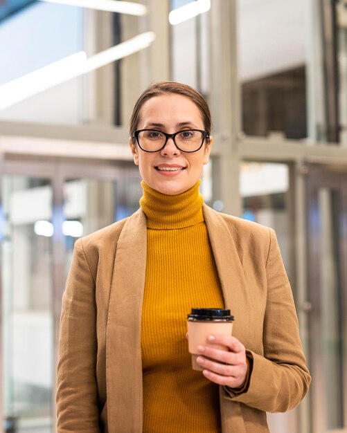 Medium shot woman holding coffee cup
