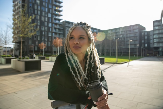 Medium shot woman holding coffee cup