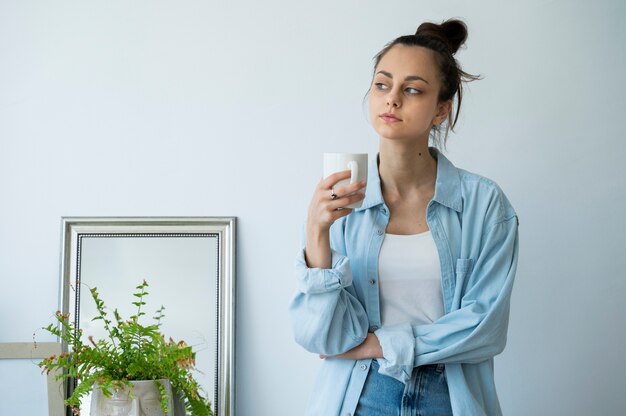 Medium shot woman holding coffee cup