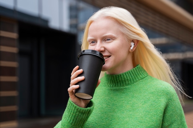 Medium shot woman holding coffee cup