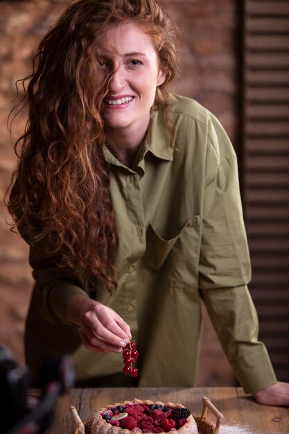 Medium shot woman holding cranberries