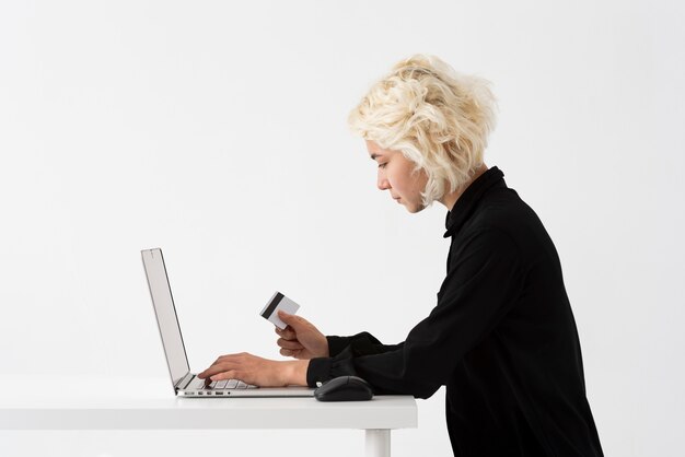 Medium shot woman holding credit card