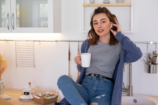 Medium shot woman holding cup