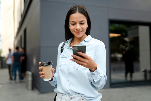 Medium shot woman holding device