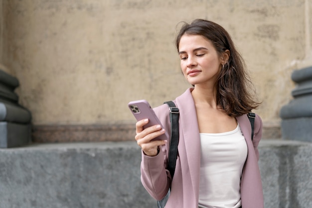 Medium shot woman holding device