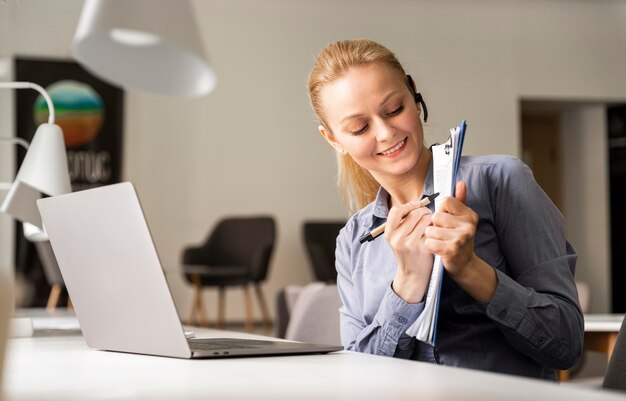 Medium shot woman holding document