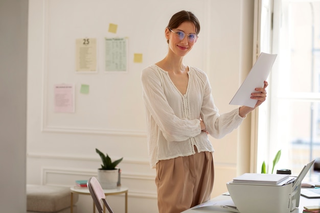 Medium shot woman holding documents