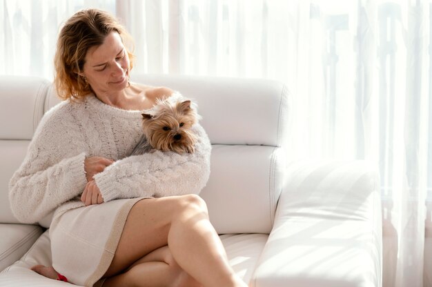 Medium shot woman holding dog