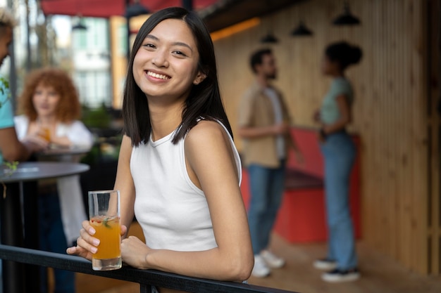 Medium shot woman holding drink