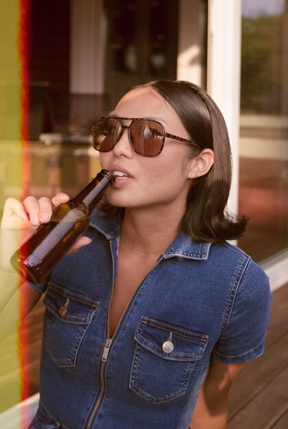 Medium shot woman holding drink