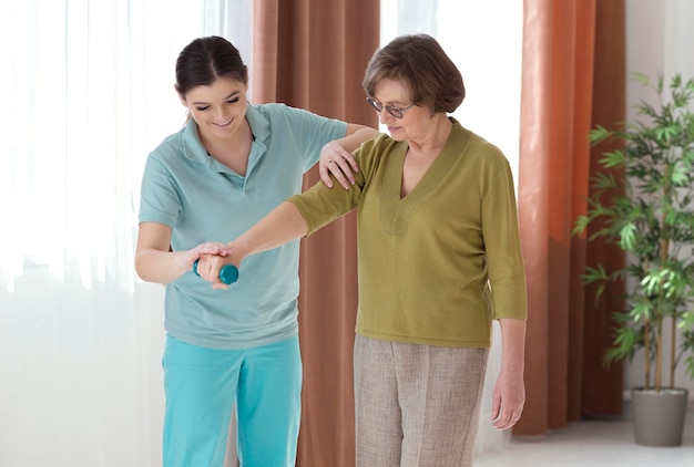 Medium shot woman holding dumbbell