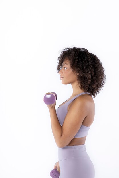 Medium shot woman holding dumbbells