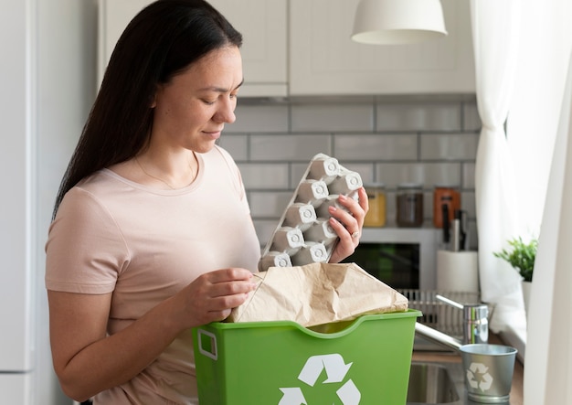 Free photo medium shot woman holding egg carton