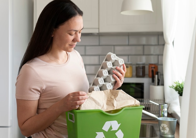 Medium shot woman holding egg carton