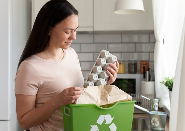 medium shot woman holding egg carton
