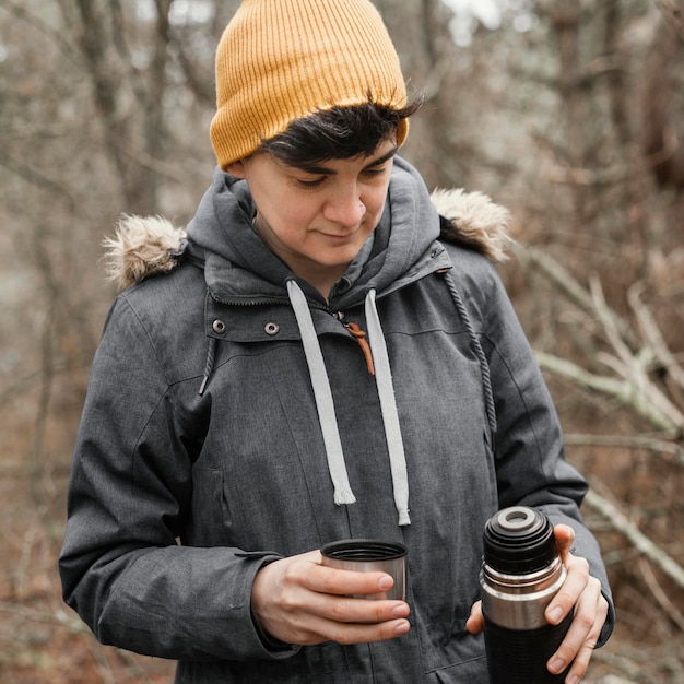 Medium shot woman holding flask