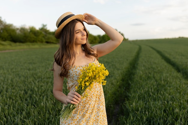 Foto gratuita donna con colpo medio che tiene i fiori