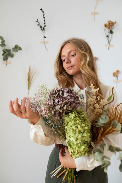 Medium shot woman holding flowers