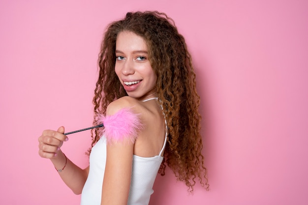 Free photo medium shot woman holding fluffy sex toy