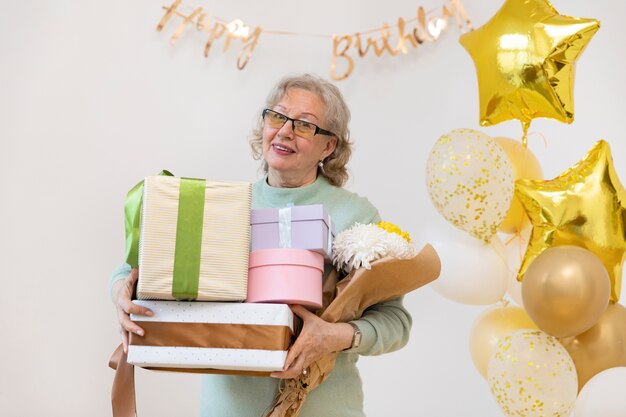 Medium shot woman holding gifts